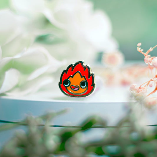Flame-shaped character pin on a blurred floral background